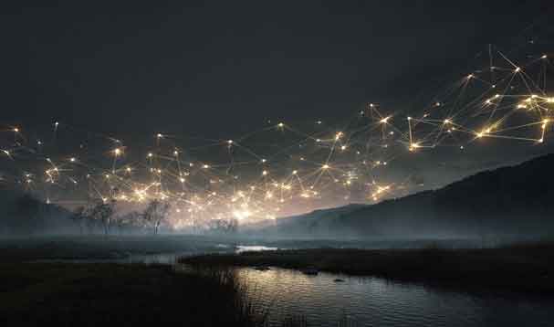 a stretch of night sky and mountain range with connected constellations over the ocean